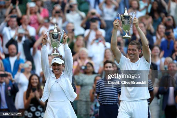 Desirae Krawczyk of The United States and partner Neal Skupski of Great Britain hold up their Trophies after winning the Mixed Doubles Final against...