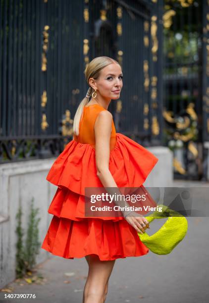 Leonie Hanne seen wearing orange red dress, yellow Bottega Veneta bag outside Rami Al Ali during Paris Fashion Week - Haute Couture Fall Winter 2022...