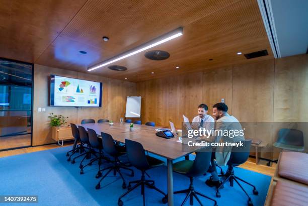 business people working in a board room with a laptop and digital tablet. - lawyers serious stock pictures, royalty-free photos & images