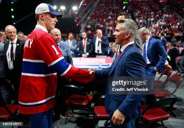 Juraj Slafkovsky of the Montreal Canadiens, first overall pick of the 2022 Upper Deck NHL Draft, shakes hands with head coach Martin St. Louis at...