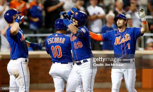 Davis of the New York Mets celebrates his fifth inning grand slam home run against the Miami Marlins with teammates Mark Canha, Eduardo Escobar and...
