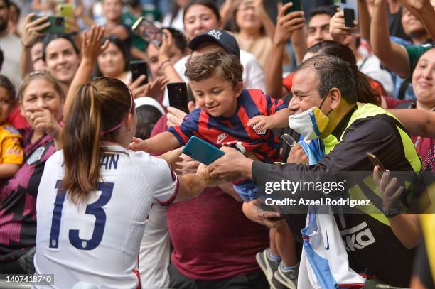 Alex Morgan of USA approaches to fan Luca at the end of the match between Jamaica and United States as part of the 2022 Concacaf W Championship at...