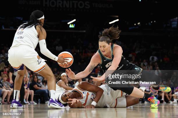 Stefanie Dolson of the New York Liberty and Reshanda Gray of the Phoenix Mercury dive for a loose ball during the first half of the WNBA game at...