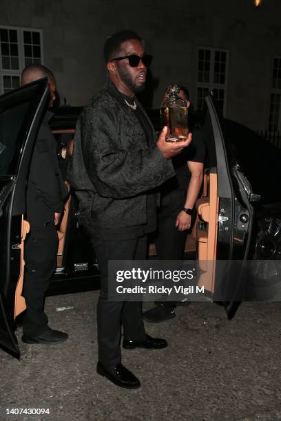 Sean Diddy Combs seen celebrating Naomi Campbell's honorary doctorate presented to her during the graduation ceremony of UCA Epsom students with a...