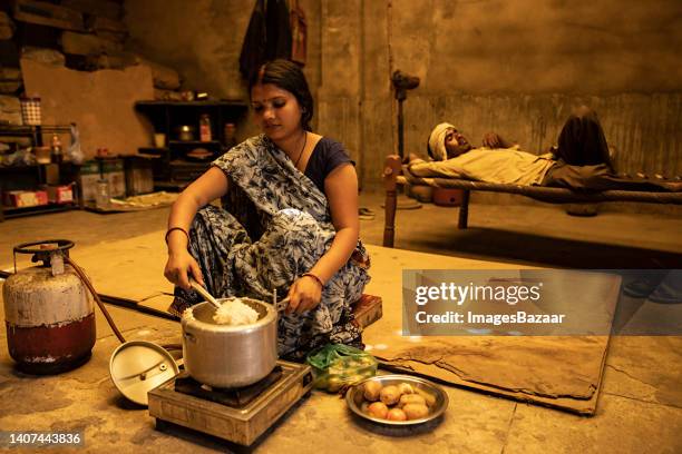 mid adult woman cooking food in the factory - rice production stock pictures, royalty-free photos & images