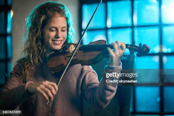 happy woman playing violin. - classical musician stock pictures, royalty-free photos & images