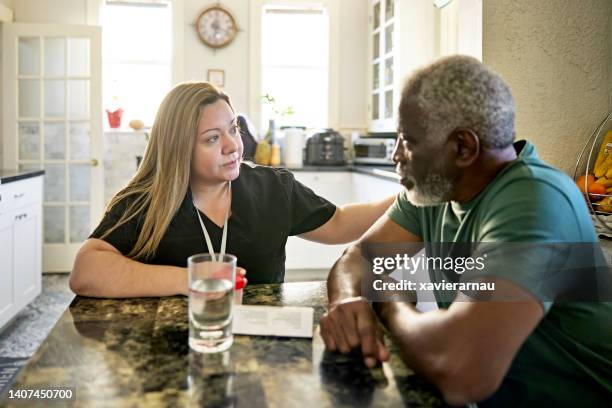 healthcare worker talking with senior client - emotional support 個照片及圖片檔