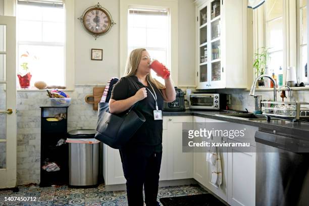 healthcare worker in client’s kitchen during house call - s thirtysomething stock pictures, royalty-free photos & images