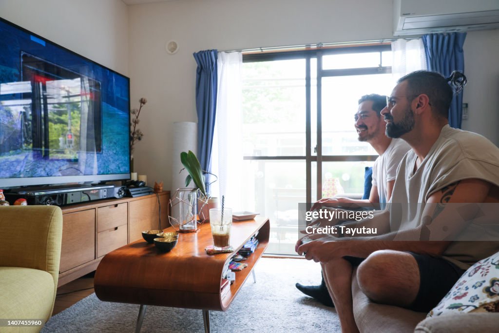 Two men playing games at home.