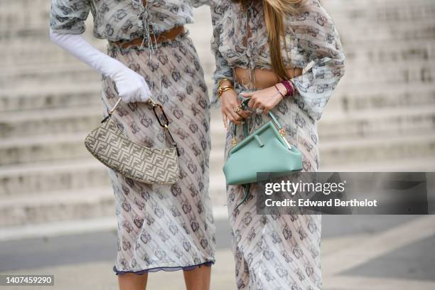 Leonie Hanne wears a beige with gray chain F monogram print pattern ruffled / puffy short sleeves / cropped knot waist top from Fendi, a matching...