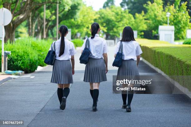 back view of a walking high school girl - female high school student stock pictures, royalty-free photos & images