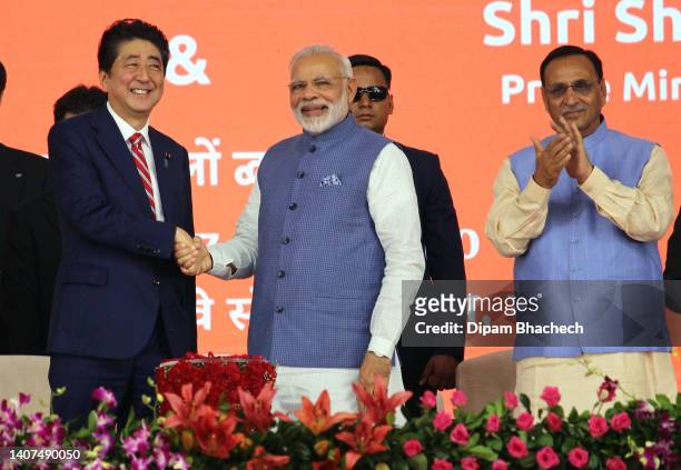 Indian Prime Minister Narendra Modi and Japanese Prime Minister Shinzo Abe shake hands at the ground-breaking ceremony of the Mumbai-Ahmedabad High...
