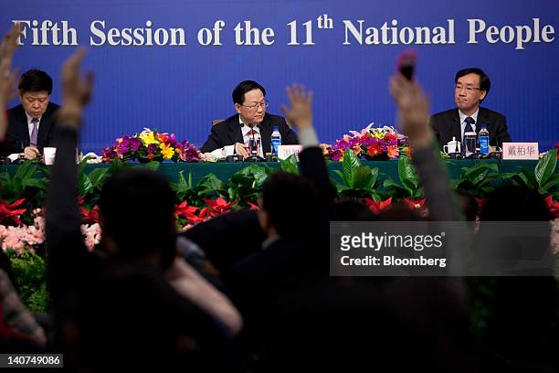 Xie Xuren, China's finance minister, center, takes questions during a news conference at the China's National People's Congress in Beijing, China, on...