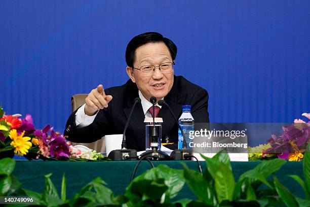 Xie Xuren, China's finance minister, gestures as he speaks during a news conference at the China's National People's Congress in Beijing, China, on...