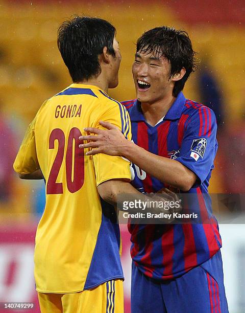 Shuichi Gonda and Jang Hyunsoo of FC Tokyo celebrate victory after the AFC Asian Champions League match between Brisbane Roar and FC Tokyo at Suncorp...