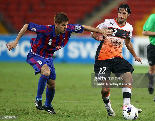 Thomas Broich of the Roar is challenged by the defence during the AFC Asian Champions League match between Brisbane Roar and FC Tokyo at Suncorp...