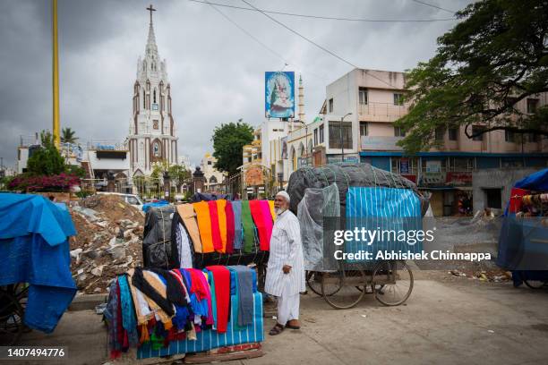 Muslim cloth seller waits for customers on a street ahead of Eid al-Adha on July 08, 2022 in Bengaluru, India. Muslims around the world will...