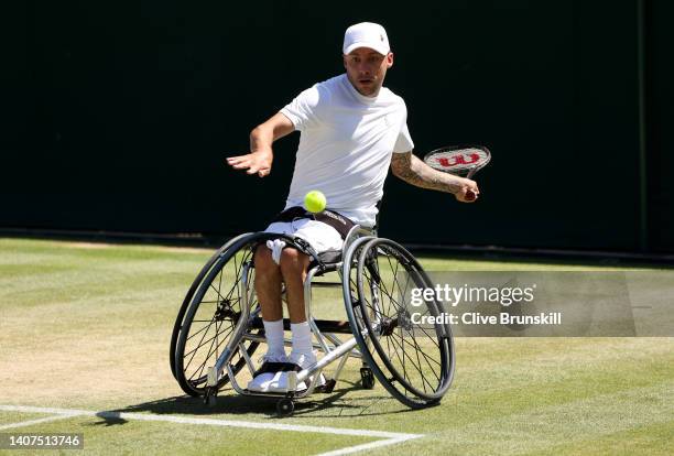 Andy Lapthorne of Great Britain plays a forehand with partner David Wagner of the United States against Donald Ramphadi of South Africa and partner...