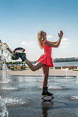 Woman in pink sportswear doing kangoo jumps training