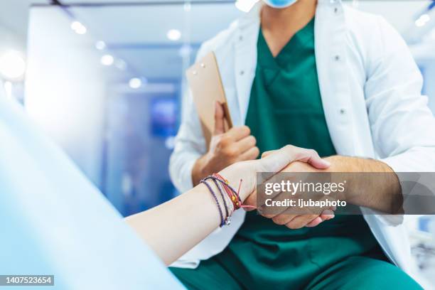 doctor and female patient meeting at the hospital and shaking hands - dental office bildbanksfoton och bilder