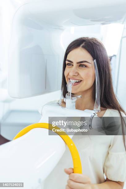 el paciente realiza una radiografía panorámica de la cavidad oral en un aparato ortopantomográfico - radiologia dental fotografías e imágenes de stock