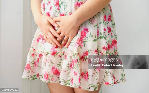 young woman in pain - woman hemorrhoids stock pictures, royalty-free photos & images