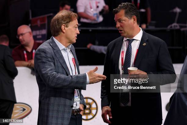 General manager Joe Sakic of the Colorado Avalanche and general manager Bill Guerin of the Minnesota Wild speak on the draft floor prior to the start...