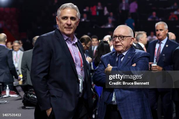 General manger Ron Francis of the Seattle Kraken and president of hockey operations Jim Rutherford of the Vancouver Canucks speak on the draft floor...