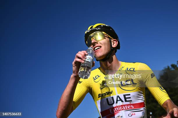 Tadej Pogacar of Slovenia and UAE Team Emirates Yellow Leader Jersey celebrates winning and cools down to refresh itself during the 109th Tour de...