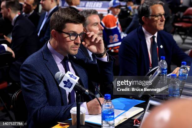 General manager Kyle Dubas of the Toronto Maple Leafs looks on from the draft table during Round Two of the 2022 Upper Deck NHL Draft at Bell Centre...