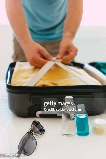 packing suitcase for travel vacation in new normal - toiletries stock pictures, royalty-free photos & images