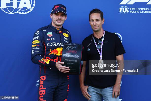 Pole position qualifier Max Verstappen of the Netherlands and Oracle Red Bull Racing is presented with the Pirelli Pole Position trophy by Mathias...