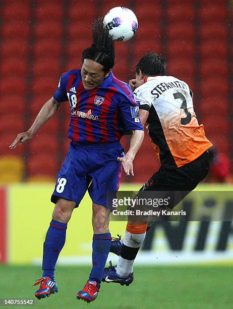 Ishikawa Naohiro of Tokyo and Shane Stefanutto of the Roar compete for the ball during the AFC Asian Champions League match between Brisbane Roar and...