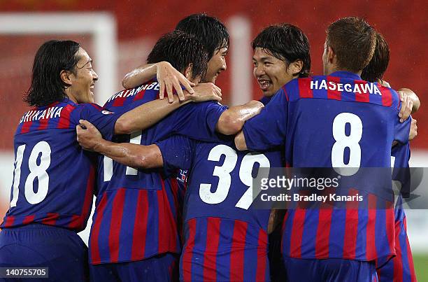 Yazawa Tatsuya of Tokyo celebrates with team mates after scoring a goal during the AFC Asian Champions League match between Brisbane Roar and FC...