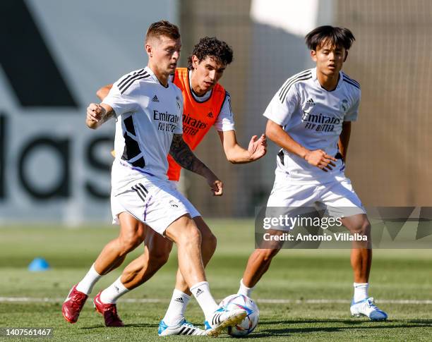 Toni Kroos player of Real Madrid is training with teammates Jesus Vallejo and Takefusa Kubo at Valdebebas training ground on July 08, 2022 in Madrid,...