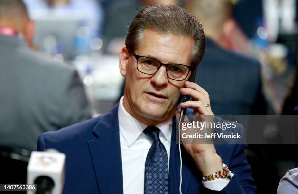 General manager Ron Hextall of the Pittsburgh Penguins talks on his phone at the draft table during the first round of the 2022 Upper Deck NHL Draft...