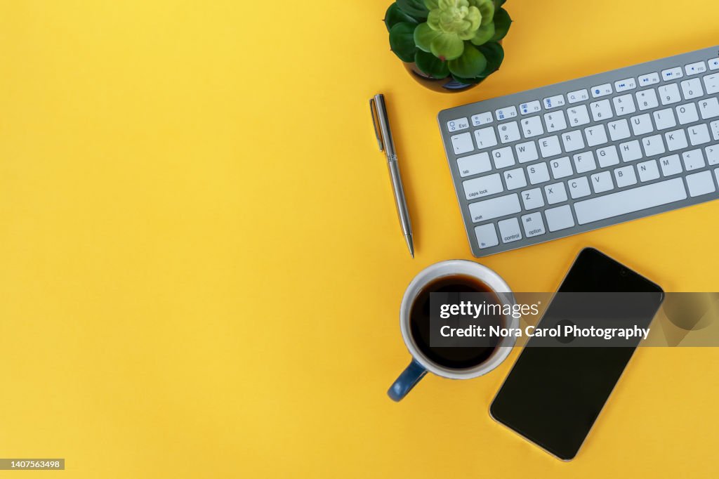 Office Desk on Yellow Background With Copy Space