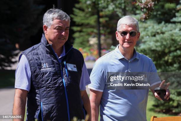 Tim Cook , CEO of Apple, walks with Eddy Cue, Senior Vice President of Services at Apple, during the Allen & Company Sun Valley Conference on July...