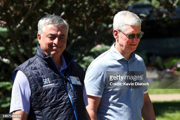 Tim Cook , CEO of Apple, walks with Eddy Cue, Senior Vice President of Services at Apple, during the Allen & Company Sun Valley Conference on July...