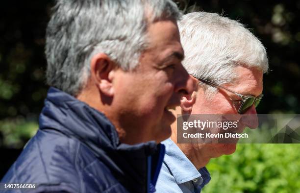 Tim Cook , CEO of Apple, walks with Eddy Cue, Senior Vice President of Services at Apple, during the Allen & Company Sun Valley Conference on July...