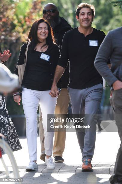 Sheryl Sandberg, outgoing Chief Operating Officer at Meta Platforms, Inc., and her partner Tom Bernthal walk to a morning session during the Allen &...