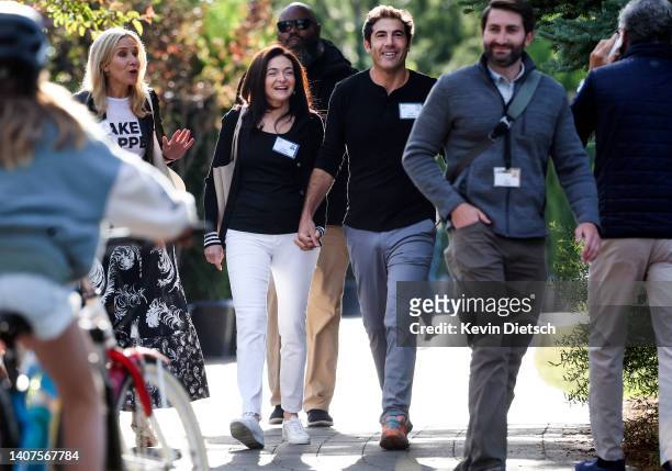 Sheryl Sandberg, outgoing Chief Operating Officer at Meta Platforms, Inc., and her partner Tom Bernthal walk to a morning session during the Allen &...
