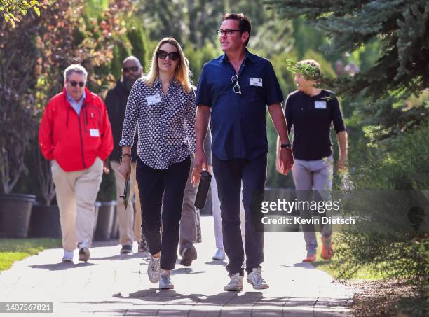 James Murdoch, son of media mogul Rupert Murdoch, and his wife Kathryn Murdoch walk to a morning session during the Allen & Company Sun Valley...