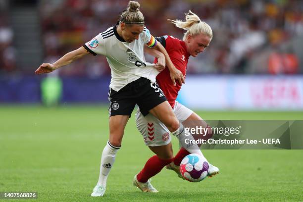 Svenja Huth of Germany battles for possession with Rikke Madsen of Denmark during the UEFA Women's Euro 2022 group B match between Germany and...