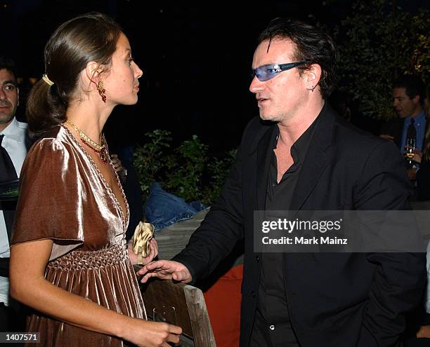 Lead singer Bono from the group U2 chats with model Christy Turlington at the book launch for her new book "Living Yoga" September 19, 2002 hosted by...