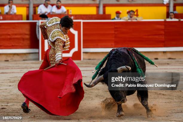 Bullfighter Alvaro Lorenzo performs with Fuente Ymbro's fighting bulls in the bullring during the third day of the San Fermin Running of the Bulls...