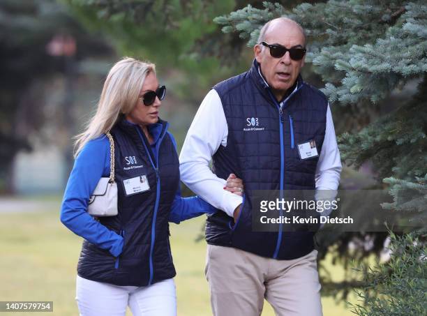 Muhtar Kent, Chairman of the Board and Chief Executive Officer at The Coca-Cola Company, walks with Monica Meacci during the Allen & Company Sun...