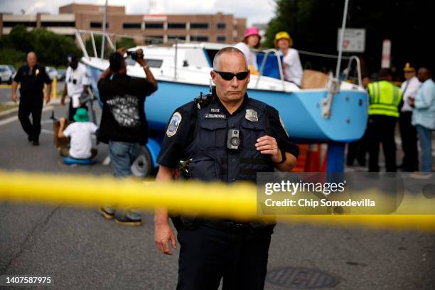Metro DC Police isolate and surround a boat left in the middle of the street by members of Extinction Rebellion Washington to block traffic as part...