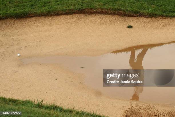 Reflection in the water as Wesley Bryan of the United States prepares to play a shot from the bunker on the 18th hole during the second round of the...