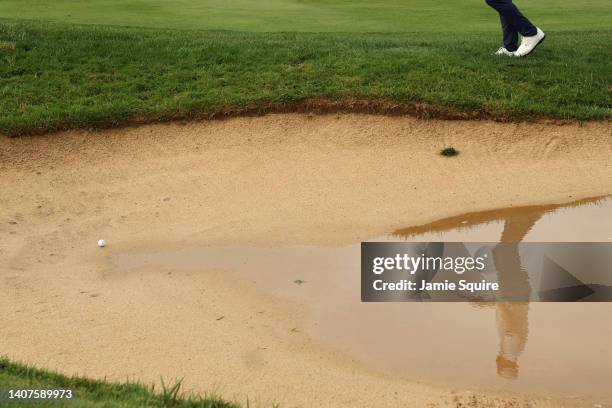 Reflection in the water as Wesley Bryan of the United States prepares to play a shot from the bunker on the 18th hole during the second round of the...